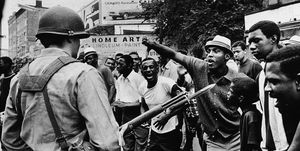 a black man gestures with his thumb down to an armed national guardman, during a protest in the newark race riots, newark, new jersey, july 14, 1967 photo by neal boenzinew york times cogetty images