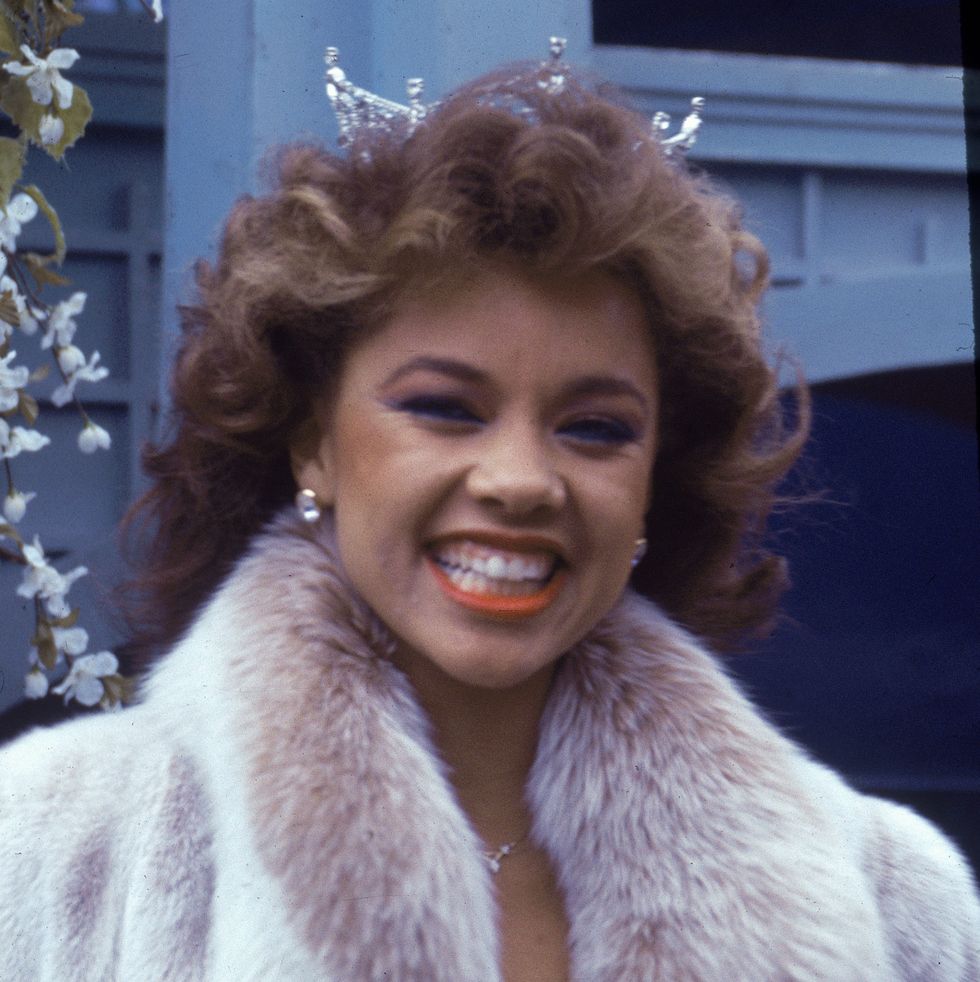 american model and actor vanessa williams, the first african   american miss america, smiles while appearing in the macys thanksgiving day parade, november 24, 1983 she wears her crown and a mink coat photo by tom gatesgetty images