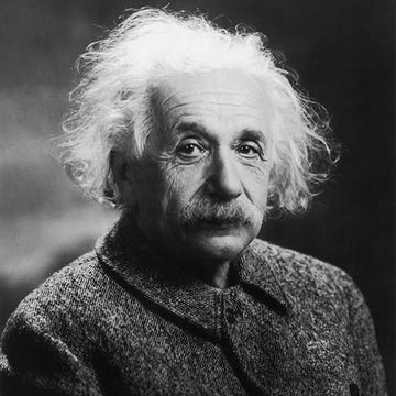 albert einstein looks at the camera with a neutral expression, he is wearing a wool coat