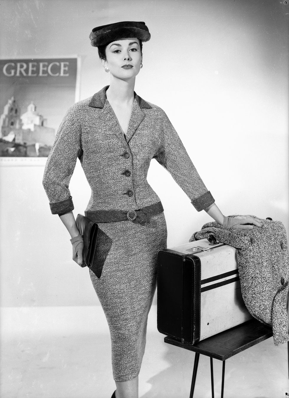 woman in a brilkie travelling outfit a belted dress with pencil skirt and a matching jacket
