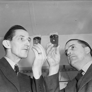 4th february 1952 whisky exporters halsall greenhill and william a mackensie examine an sample of their product photo by harold clementsexpressgetty images