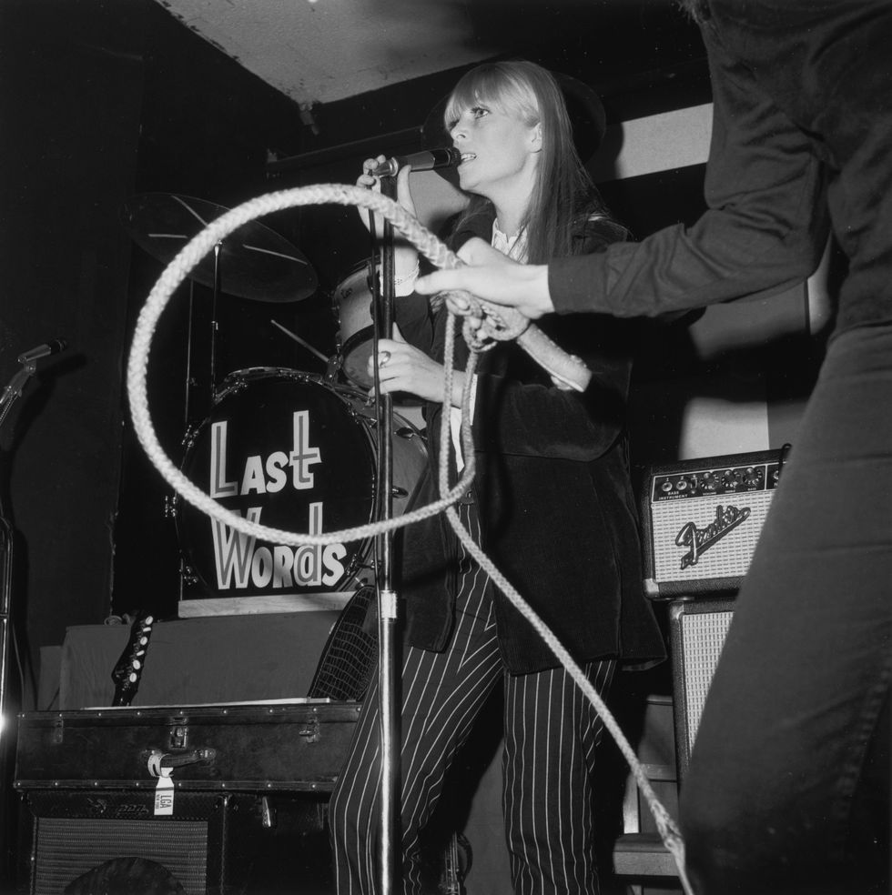 4th december 1966  nico 1938   1988, german actress, model, singer, performs with the velvet underground at a freakout party, action house disco, island park, long island, new york the arm and hand of american actor mary woronov holding a bullwhip intrudes into the scene  photo by tim boxerhulton archivegetty images