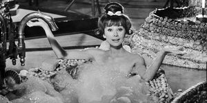 1963  belgian born actor audrey hepburn 1929   1993 holds her arms out while sitting up to her chest in soap suds in a seashell lined bathtub, in a still from director richard quines film, paris when it sizzles hepburn has bangs, long tendrils that flip up on either side, and a bun on top of her head  photo by paramount picturesgetty images