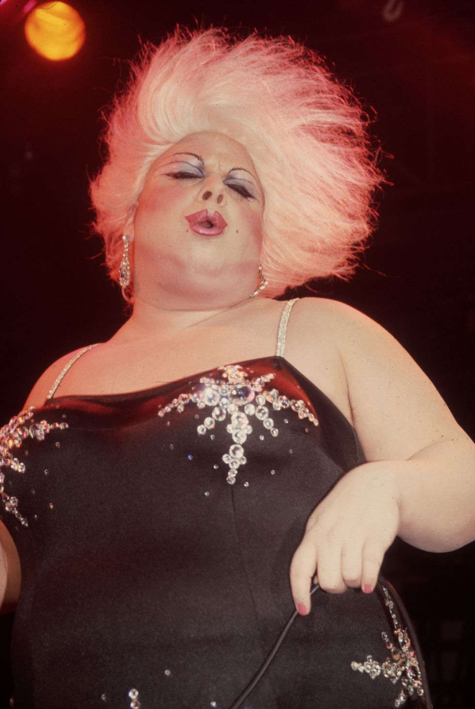 january 1983  american actor and drag queen divine born harris milstead performs at the red parrot nightclub in new york city divine is wearing a platinum blond wig, make up, and a black spaghetti strap dress  photo by tom gateshulton archivegetty images