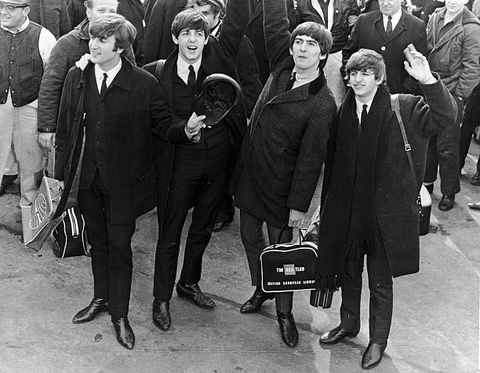 circa 1964  the british rock group the beatles wave to a crowd at an airport as they arrive in the us for concerts and television appearances  photo by hulton archivegetty images