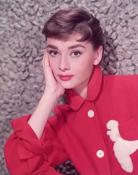 audrey hepburn beauty secrets circa 1955 headshot portrait of belgian born actor audrey hepburn 1929 1993 leaning on her hand in a red jacket with a poodle applique photo by hulton archivegetty images