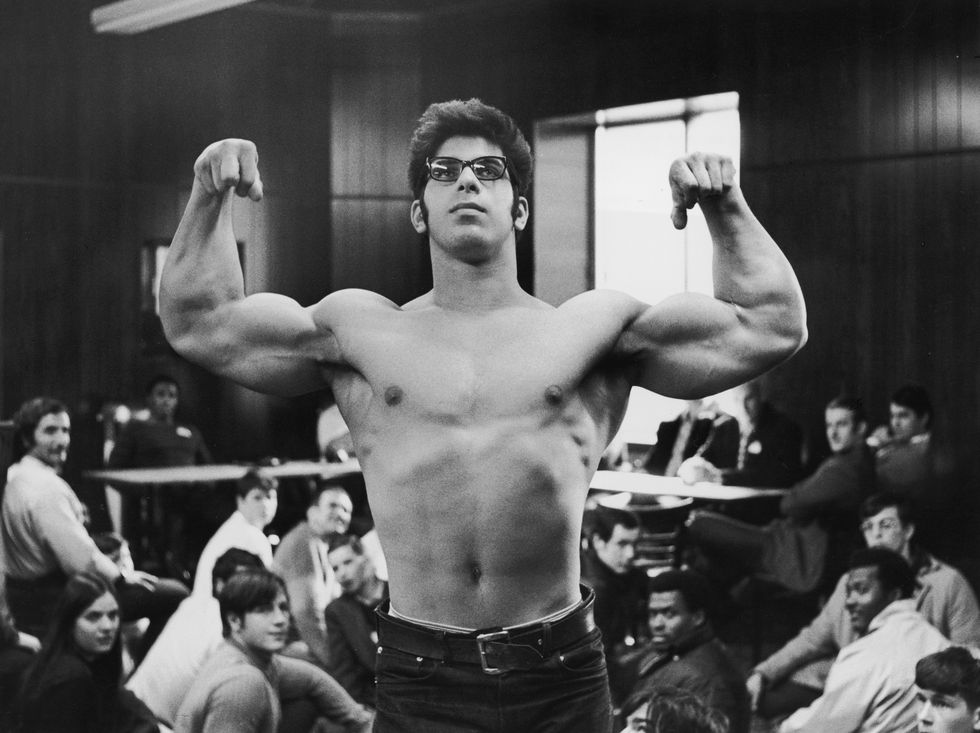 1971  american bodybuilder and actor lou ferrigno stands and flexes his biceps as a group of men watch, in his first public appearance at the wbbg clinic held at the dan lurie gym, brooklyn, new york city  photo by deniegetty images