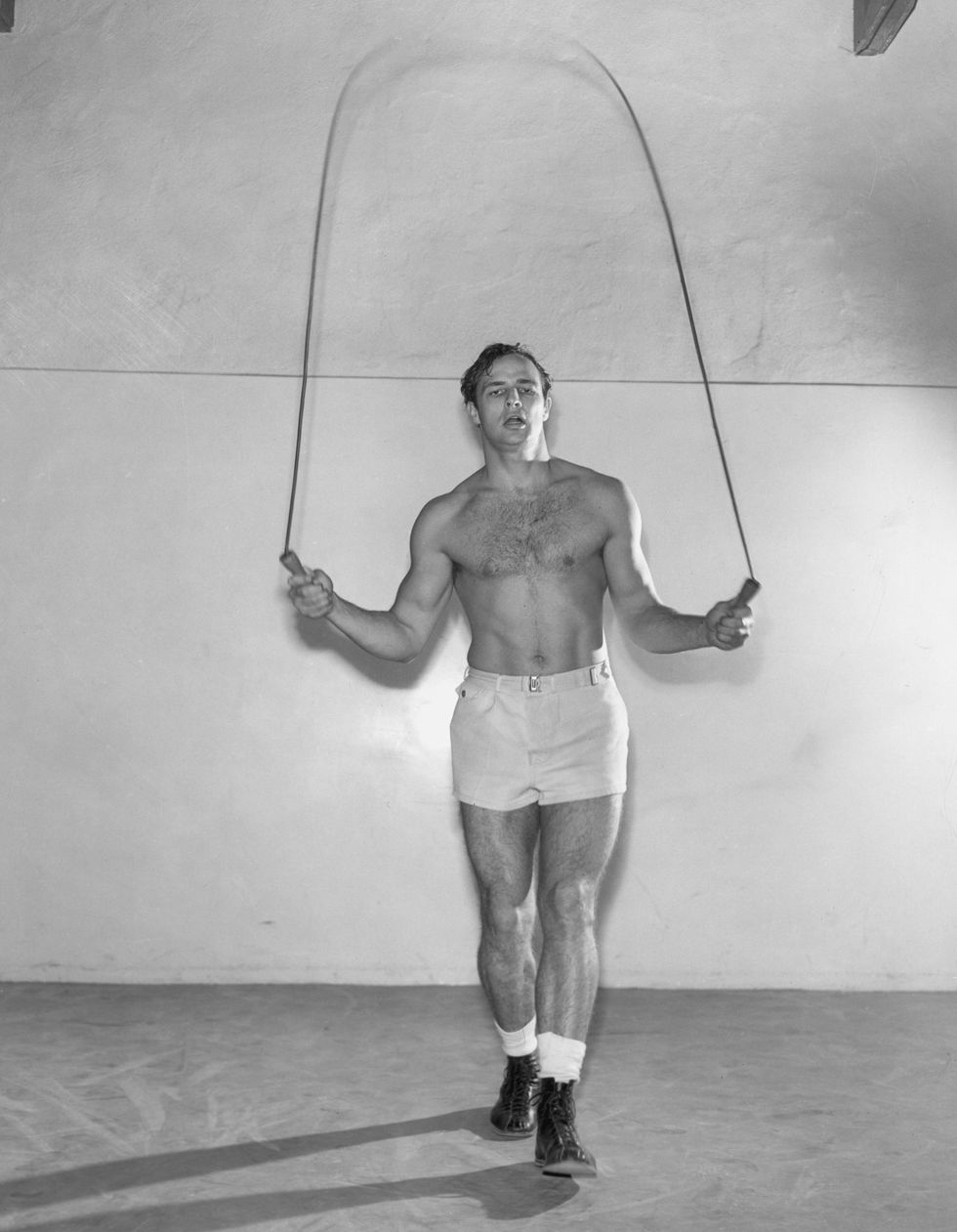 circa 1955  american actor marlon brando jumps rope wearing boots, shorts and no shirt  photo by hulton archivegetty images