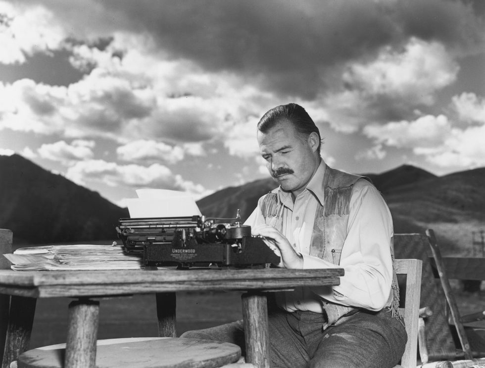 7th october 1939  exclusive american writer ernest hemingway 1899   1961 works at his typewriter while sitting outdoors, idaho hemingway disapproved of this photograph saying, 'i don't work like this'  photo by lloyd arnoldhulton archivegetty images
