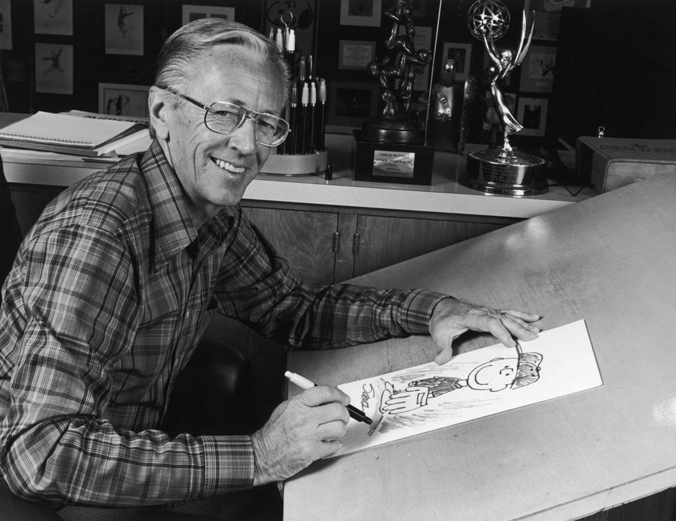 1978  portrait of american cartoonist charles m schulz 1922   2001, creator of the peanuts comic strip, sitting at his studio drawing table with a picture of his character charlie brown and some awards behind him schulz created the comic strip in 1950  photo by cbs photo archivegetty images