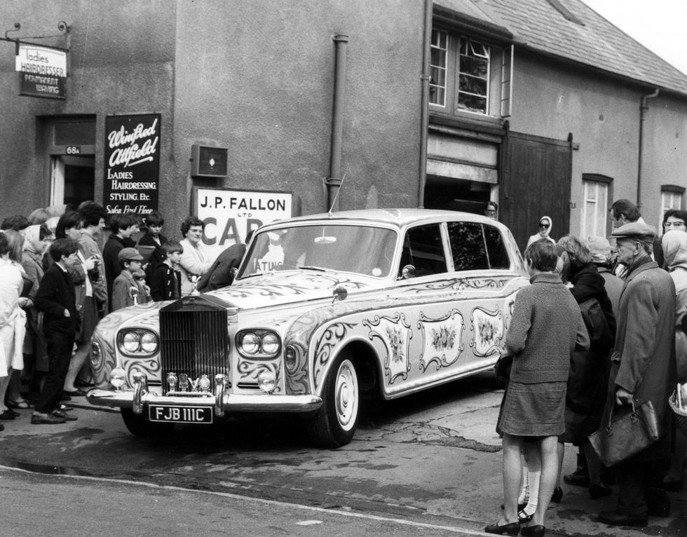 26th may 1967  a crowd gathers to stare at a luridly painted rolls royce leaving the coachbuilders after a re spray the car, belonging to beatle john lennon, was a plain black £6,000 phantom v when it left the makers factory, but lennon decided to have it custom painted  photo by ted westcentral pressgetty images