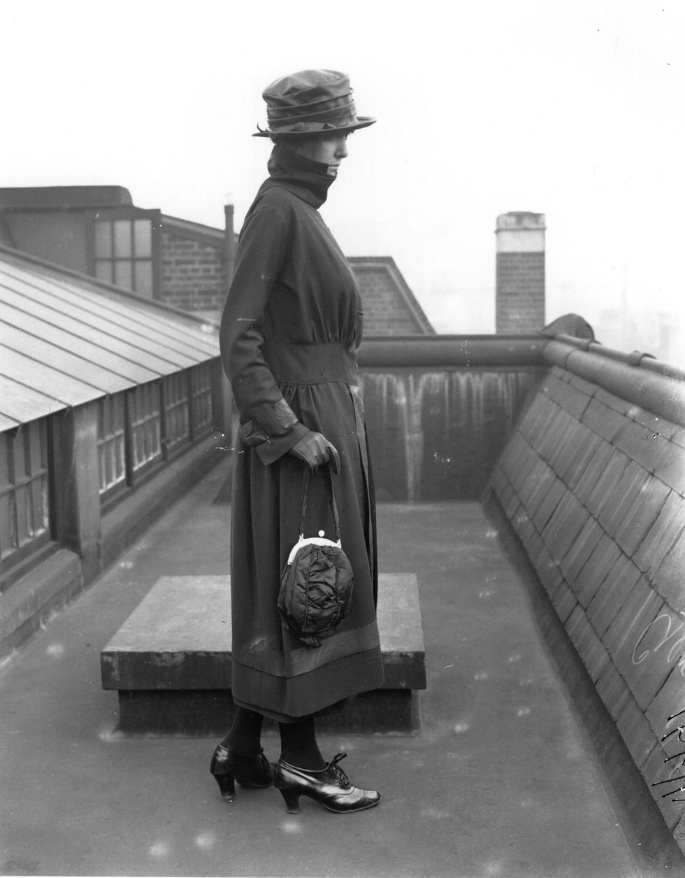 1921  a model posing on a  roof top and wearing a ruched waist suit from burberrys, london, with fur collar and gauntlet gloves  photo by central pressgetty images