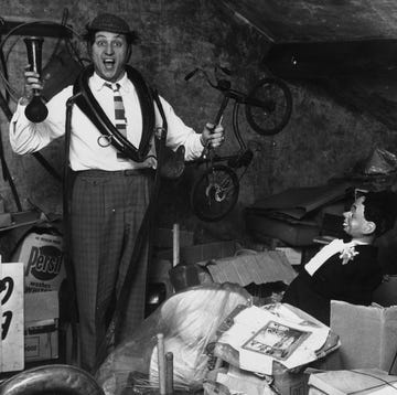 29th november 1963 liverpudlian comedian ken dodd sorts through a heap of junk, including a ventriloquists dummy, a childs bicycle and a foghorn in the attic of his house photo by john prattkeystone featuresgetty images