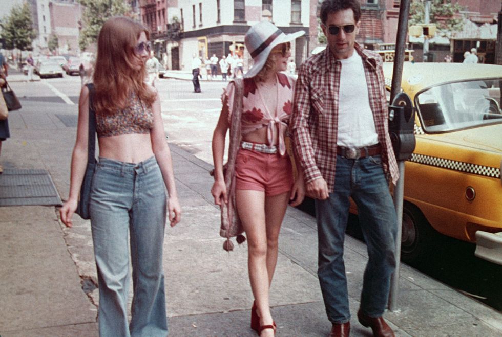 1976 american actors jodie foster, center, and robert de niro walk past a parked taxi on a new york city street in a still from the film, 'taxi driver' directed by martin scorsese photo by columbia tristargetty images