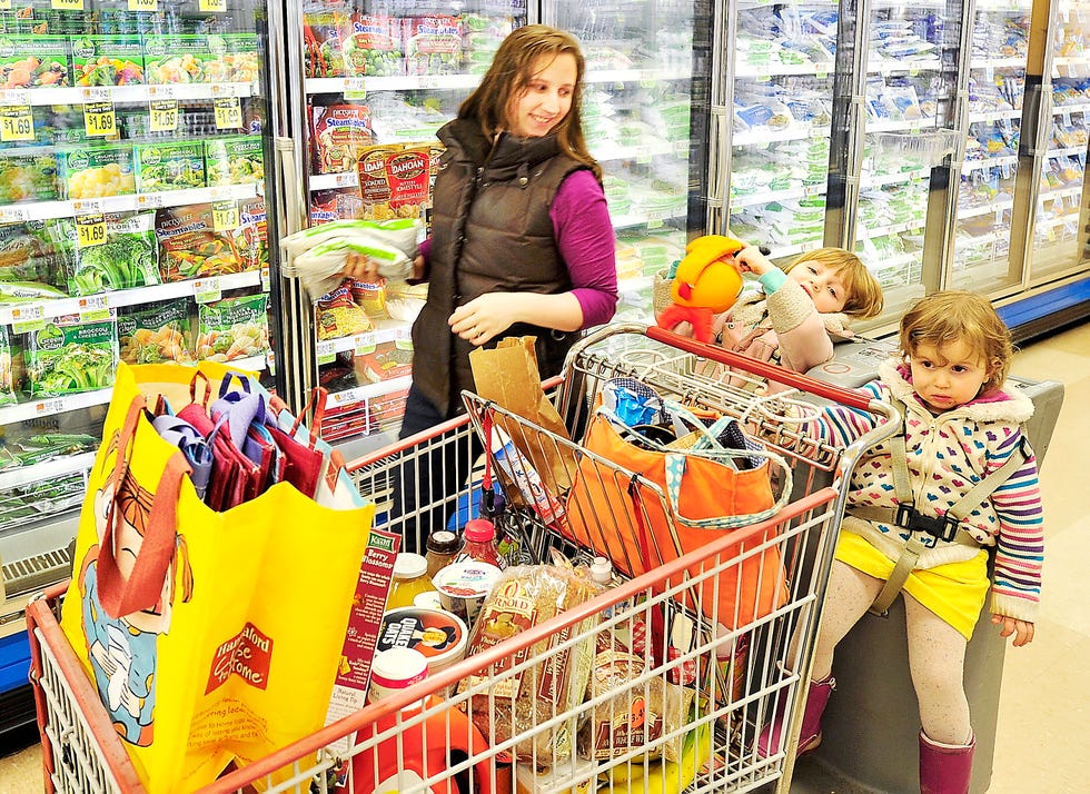 shoppers at hannafords with personal grocery bags talk