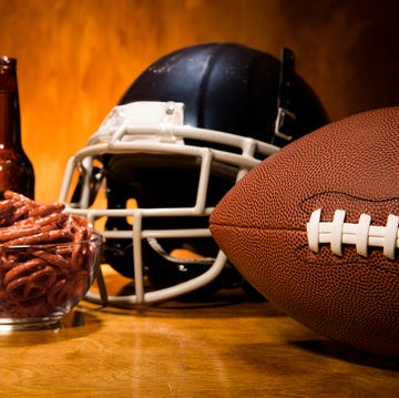 Sports:  Football helmet, ball on table.  Pretzels and beer. Superbowl.