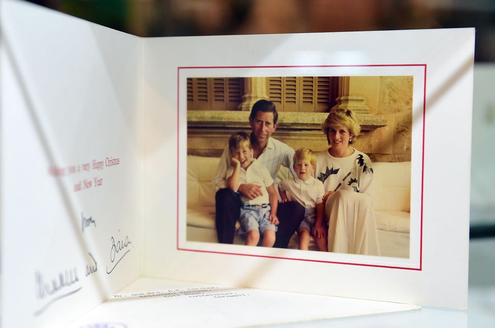 a 1987 christmas card signed by prince charles and the late princess diana is among items beside dresses on display at julien's auction house in beverly hills, california on december 1, 2014, ahead of the december 5th and 6th auction of items belonging to the late princess afp photofrederic j brown photo credit should read frederic j brownafp via getty images