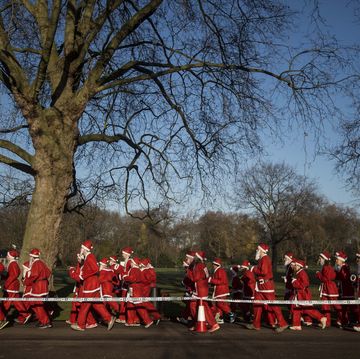 charity runners dressed as father christmas participate in the santa run charity fun run in battersea park in london on december 6, 2014 hundreds of participants dressed in santa suits and white beards ran through battersea park in aid of winter sports charity disability snowsport in this 6km festive fun run afp photo niklas hallen photo credit should read niklas hallenafp via getty images
