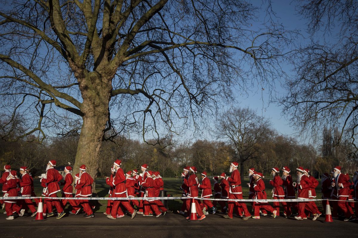charity runners dressed as father christmas participate in the santa run charity fun run in battersea park in london on december 6, 2014 hundreds of participants dressed in santa suits and white beards ran through battersea park in aid of winter sports charity disability snowsport in this 6km festive fun run afp photo niklas hallen photo credit should read niklas hallenafp via getty images