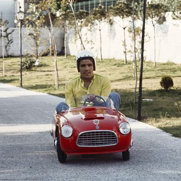 italian boxer nino benvenuti drives through the boulevard of the garden of his villa, onboard the red car of one of his sons, wearing a helmet the sportman is world champion of the welterweights italy, 1968 photo by marcello salustrimondadori via getty images