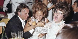 richard burton and claudia cardinale smile in an amused attitude, while elizabeth taylor cries out, catched by the snapshot of the photographer the three well dressed stars enjoy a toast during a party at vendramin calergi palace on the occasion of the 28th venice film festival venice italy, 9 september 1967 photo by mondadori via getty images
