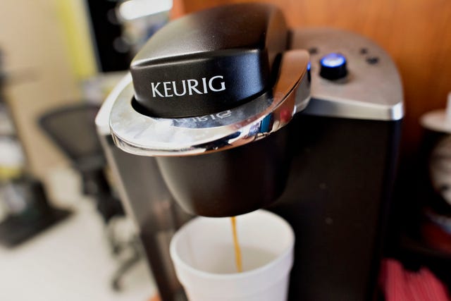 coffee flows from a keurig green mountain inc. machine in this arranged photograph taken at a retail store in princeton, illinois, u.s., on tuesday, feb. 3, 2015. keurig green mountain inc. is scheduled to report quarterly earnings on feb. 4. photographer: daniel acker/bloomberg via getty images