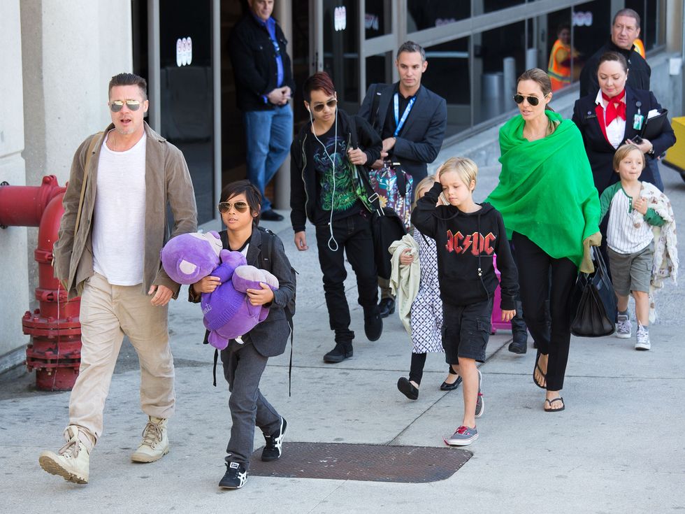 brad pitt and angelina jolie walk with their kids in 2014