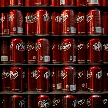 Inside The Dr. Pepper Snapple Group Inc. Bottling Plant Ahead Of Earnings Figures empty cans of dr. pepper soda sit stacked in the warehouse before being filled at the dr. pepper snapple group inc. bottling plant in louisville, kentucky, u.s., on tuesday, april 21, 2015. dr. pepper snapple group inc., producers of 7up and aw root beer, is scheduled to release earnings figures on april 23. photographer: luke sharrett/bloomberg via getty images