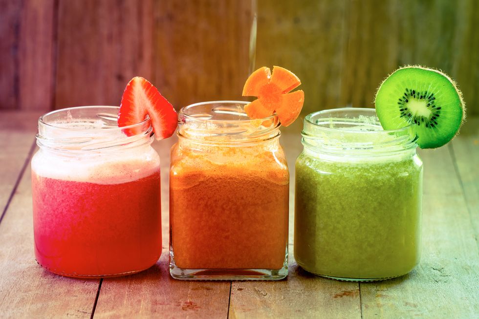 sweet color of mix fruit juice blended on wooden background