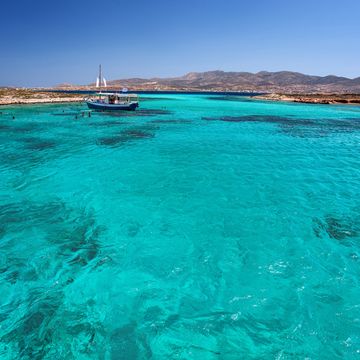 blue lagoon in tigani islet between paros and antiparos islands, cyclades, greece, with clear transparent turquoise waters