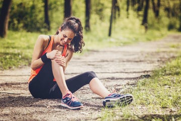 young woman feeling pain in her knee