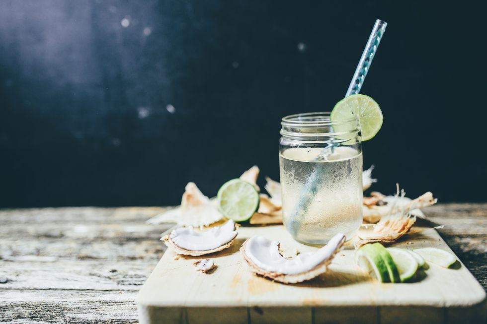 chilled coconut water in a jar with sliced lime