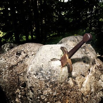 excalibur the famous sword in the stone of king arthur in the forest