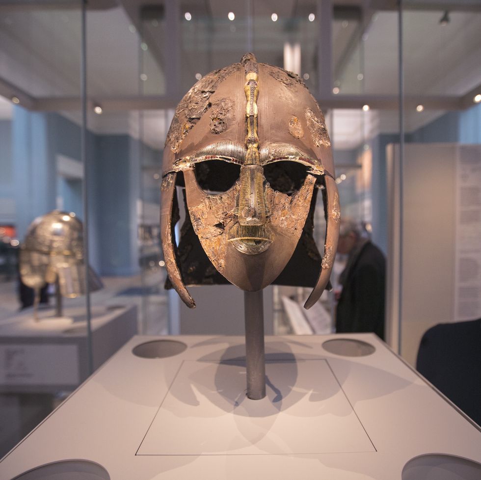 london, england   march 25  a woman views the sutton hoo helmet on display in the new gallery sutton hoo and europe ad 300 1100  in the british museum on march 25, 2014 in london, england the exhibition in the museums early medieval collections marks 75 years since the discovery of the sutton hoo treasure the gallerys centrepiece are the archelogical finds from the sutton hoo ship burial in suffolk one of britains most spectacular and important discoveries the exhibition opens to the general public on march 27, 2014  photo by oli scarffgetty images