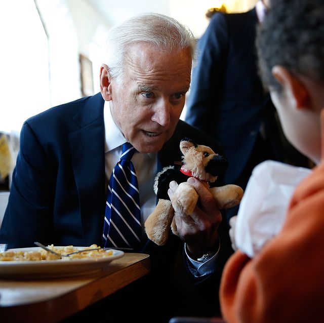 washington, dc   march 26  us vice president joe biden gives a young boy a stuffed version of bidens dog, champ, while visiting a diner march 26, 2014 in washington, dc biden visited the florida avenue grill to highlight the administrations efforts to raise the national minimum wage to 1010 an hour  photo by win mcnameegetty images