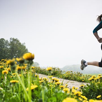 a person running in a field of flowers