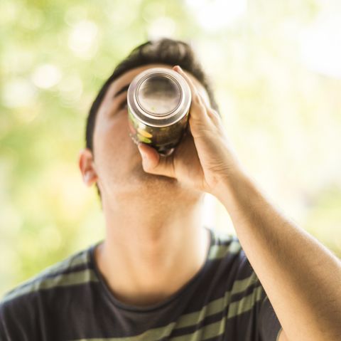 a young man drinking a can mens health diet soda weight gain loss