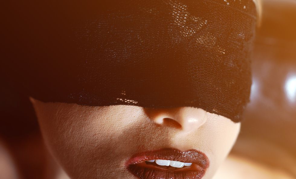 woman portrait blindfolded waiting, fetish concept, sexual gameslips in bourgundy color