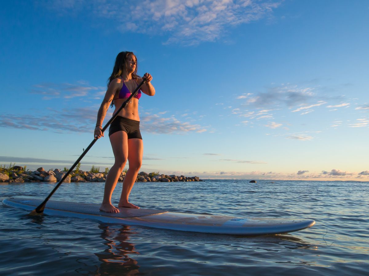 girl on a paddleboard working out