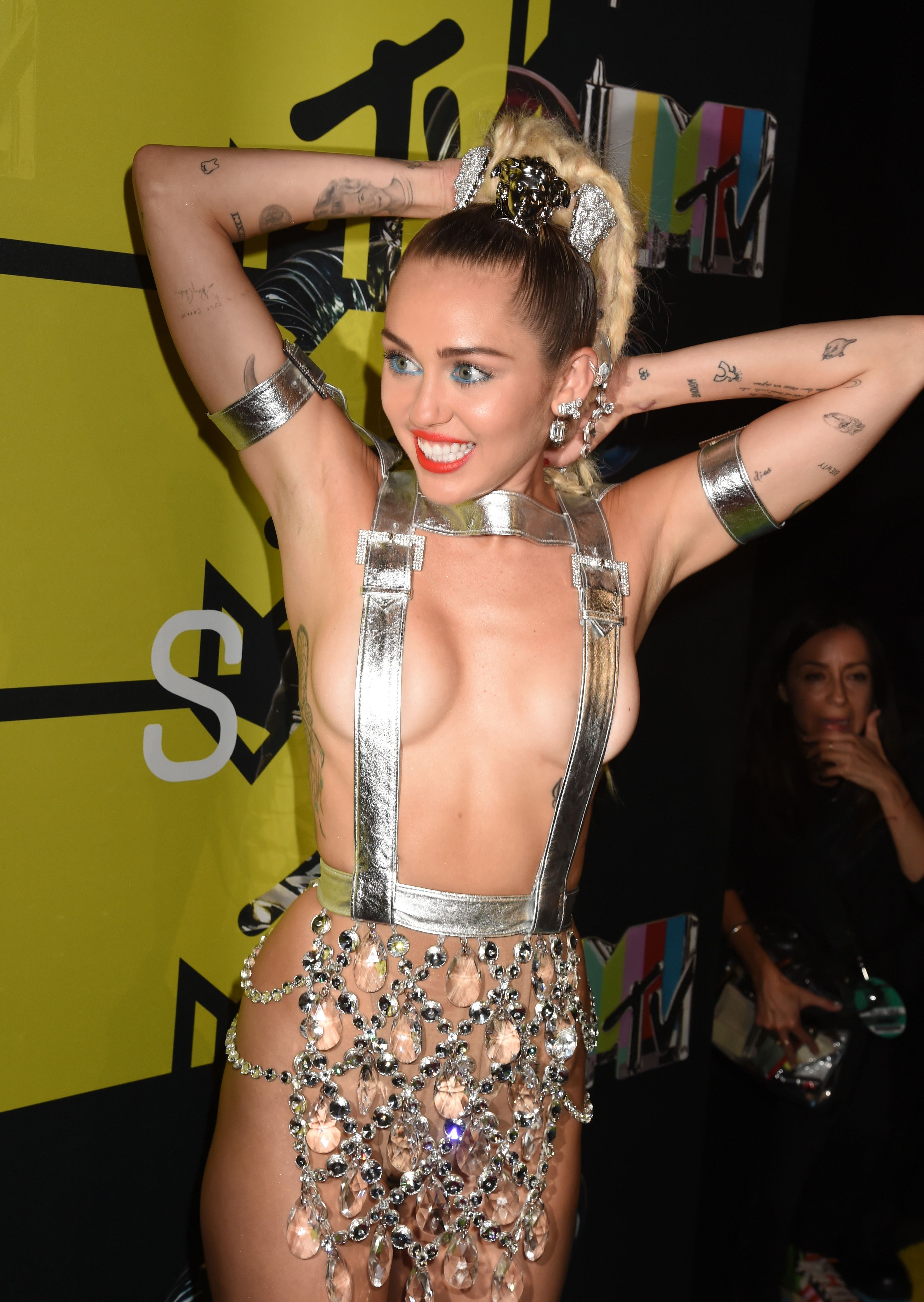 Miley Cyrus's Tattoos - Photos and Meaning of Miley Cyrus' Tattoos