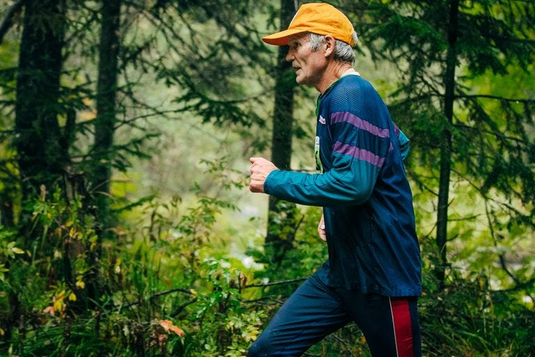 senior man running in woods