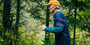 senior man running in woods