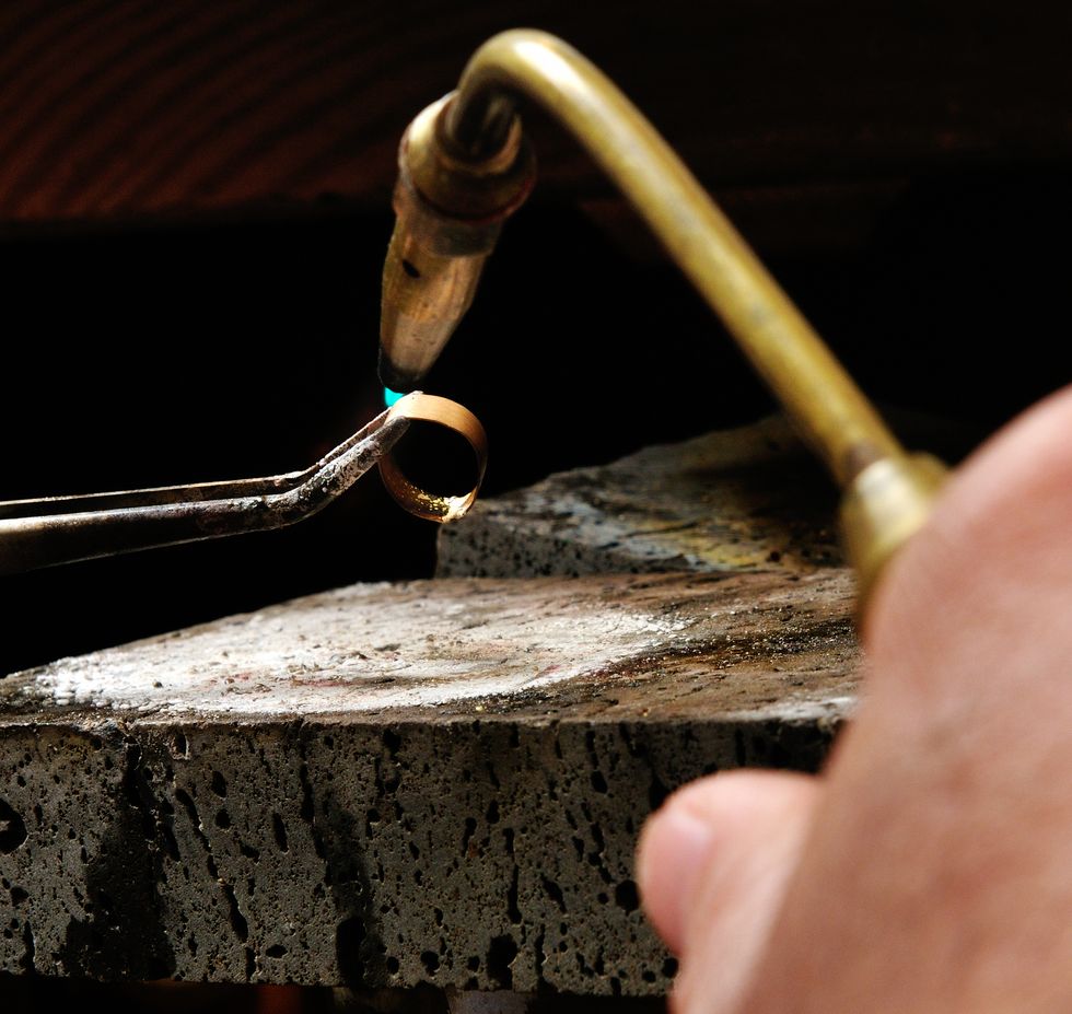 skilled hands that create handmade jewelry with gold processing