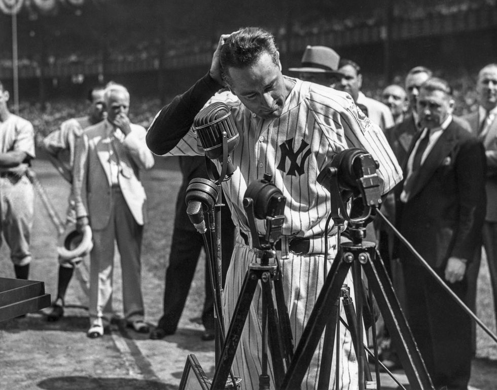 Lou Gehrig #4 of the New York Yankees is shown before the mic delivering his farewell speech on Lou Gehrig Day on July 4, 1939 at Yankee Stadium in the Bronx, New York.
