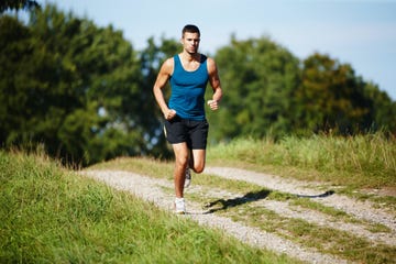 shot of a handsome young man taking a jog outdoors