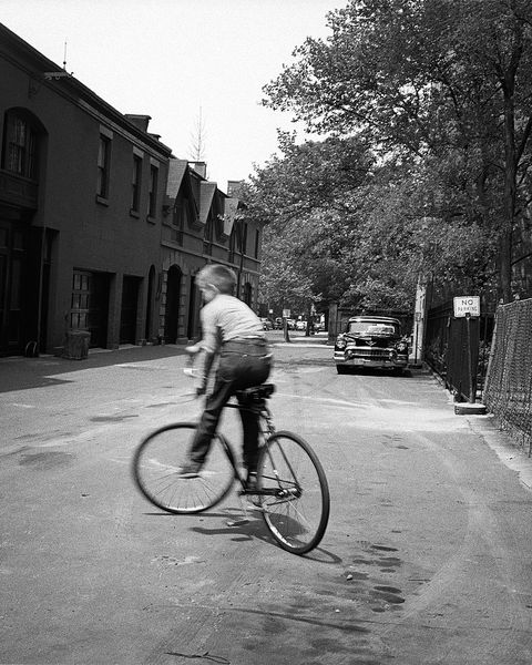 brooklyn, ny   march 1958  a young boy rides his bicycle in the street in brooklyn heights in march 1958 in new york city, new york  photo by david attiegetty images