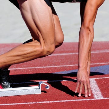 runner in the starting blocks muscular sprinter in stating blocks