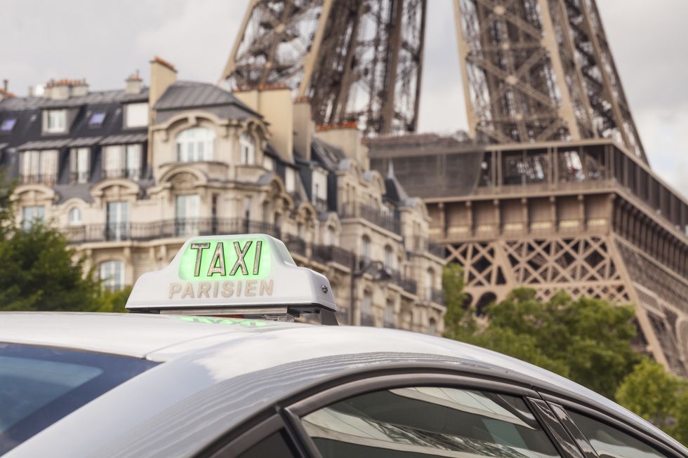 a paris taxi waiting near the eiffel tower