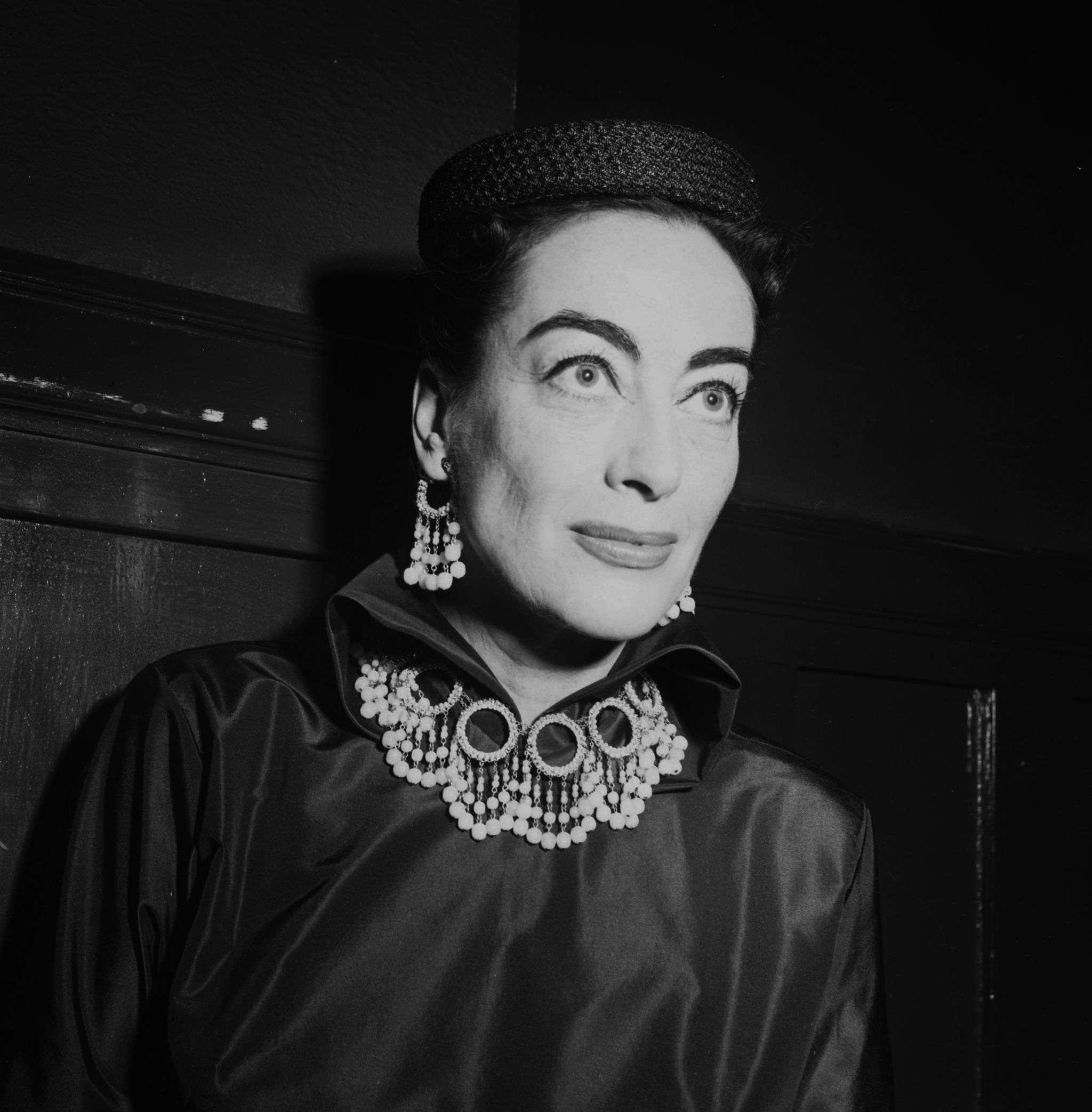 los angeles   may 18, 1954 actress joan crawford attends to guest during the joan crawford fashion show in los angeles, california photo by earl leafmichael ochs archivesgetty images