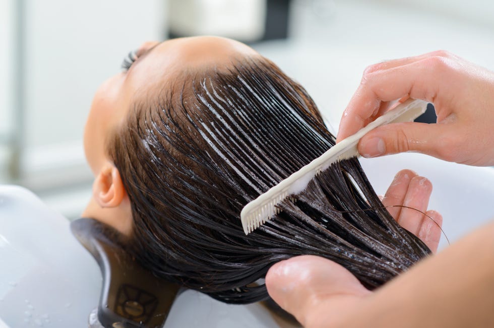professional treatment client is resting while her hair is being taken professional care